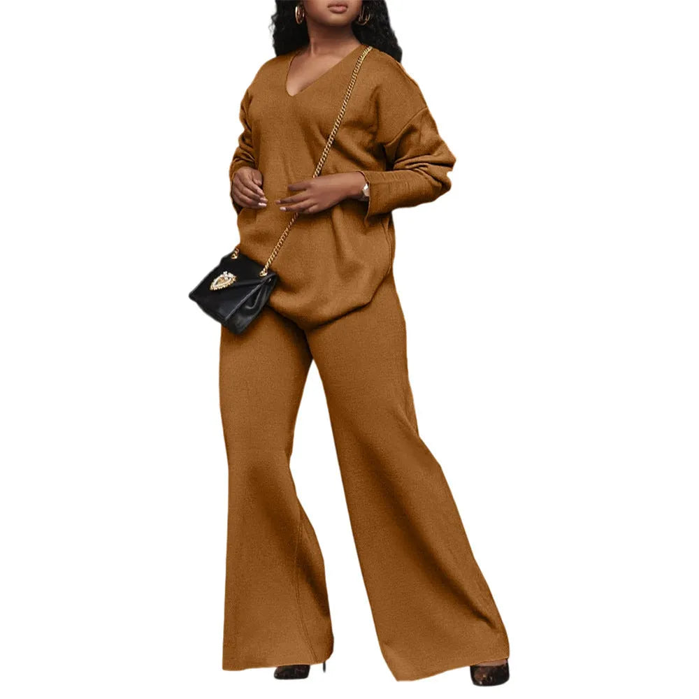 Women's brown thick suede two-piece suit with long sleeves and trousers, laid flat.