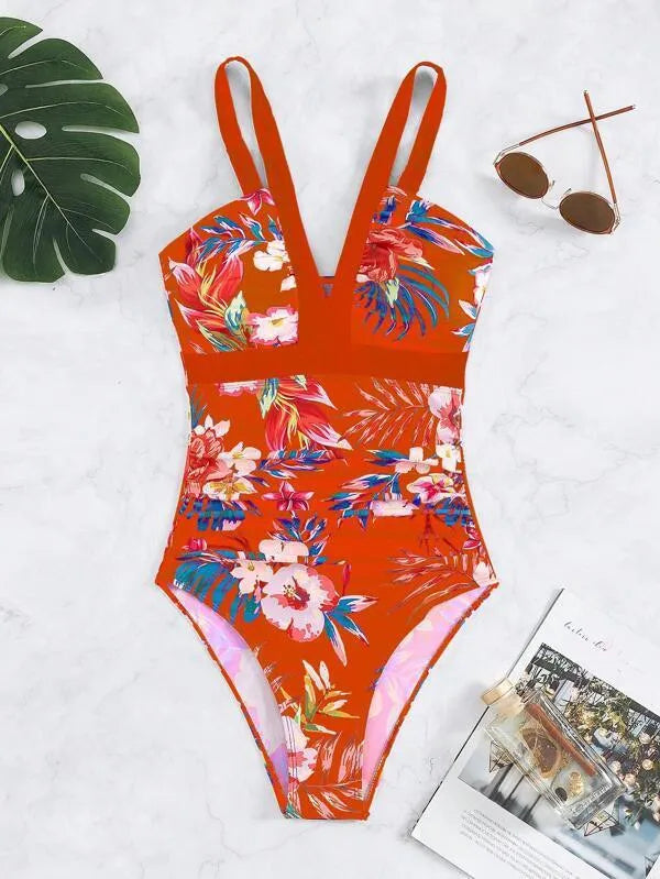 Women's floral one-piece swimsuit with backless design on a mannequin, showing high elasticity.