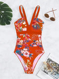 Women's floral one-piece swimsuit with backless design on a mannequin, showing high elasticity.
