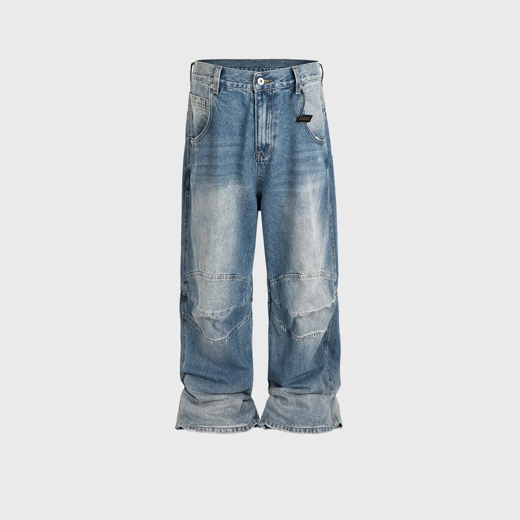 Men's blue white washed denim jeans with baggy cut and straight-leg design showing profile pleating details