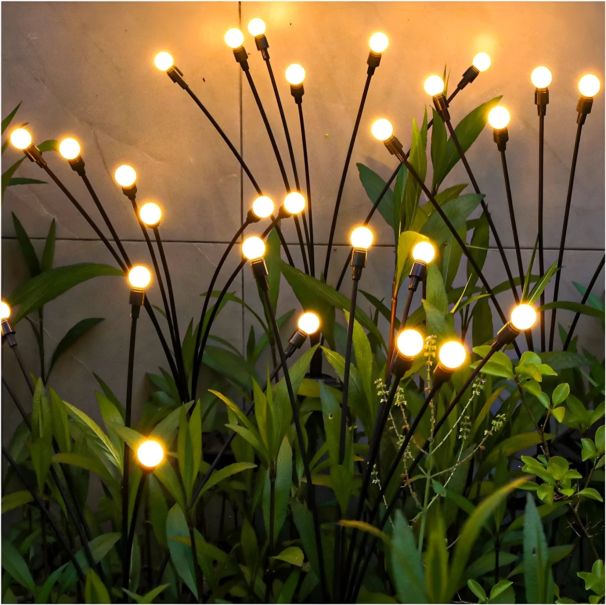 Solar-powered LED pneumatic firefly ground stake light with multiple heads on a grassy lawn.