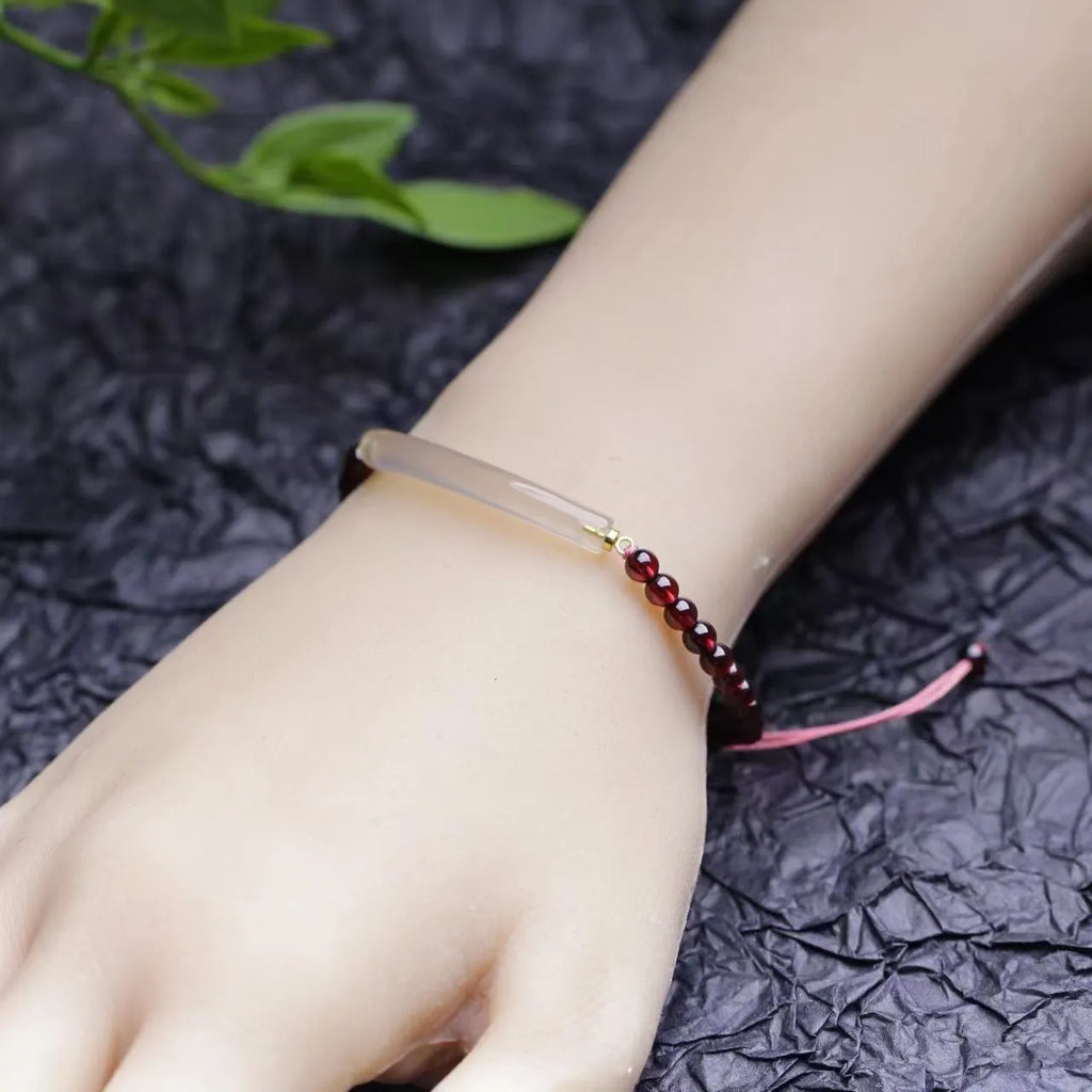 Adjustable red garnet and agate beaded bracelet with pull bead closure on wrist