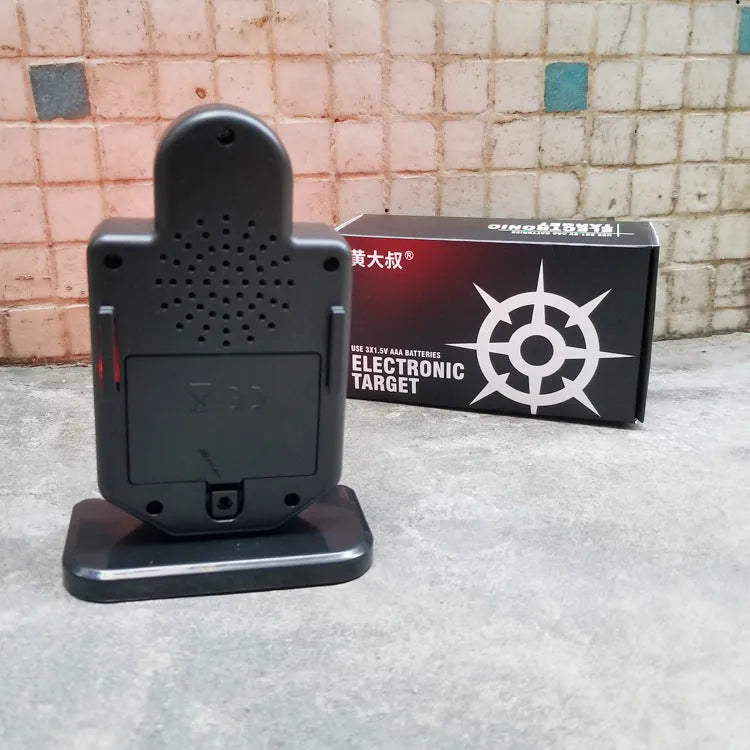 Plastic laser target with light and sound effects, dimensions 9 by 4.7 by 12.8 cm