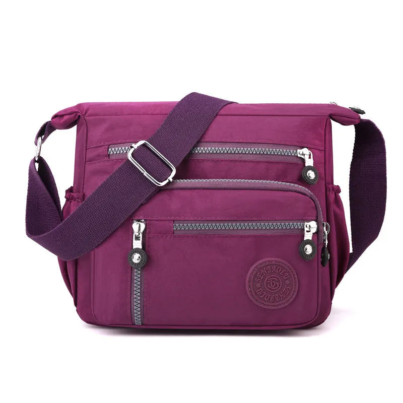 Soft grey nylon messenger bag with single shoulder strap showing square vertical shape