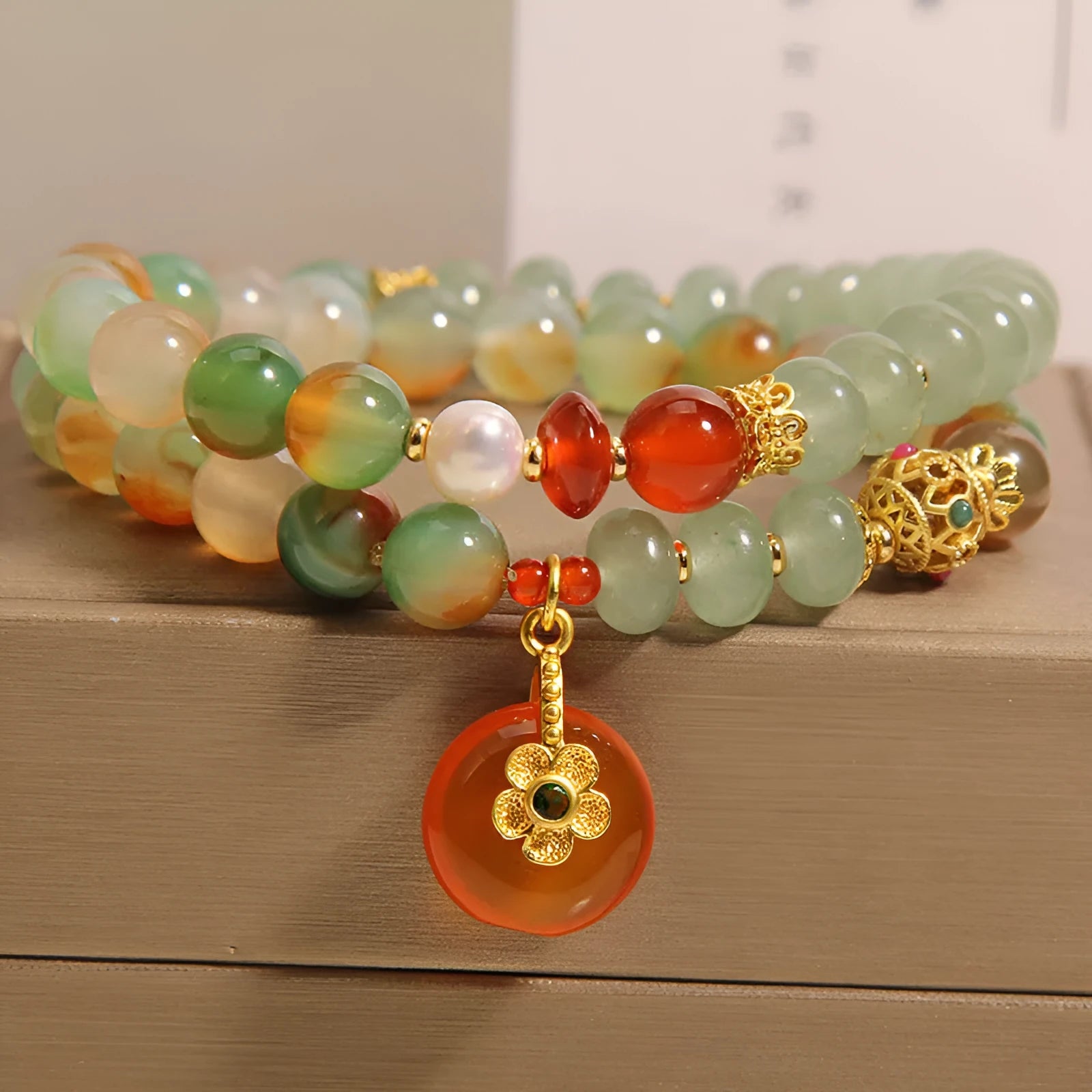 Peacock green agate double ring bracelet for women with safety buckle closure on wrist.