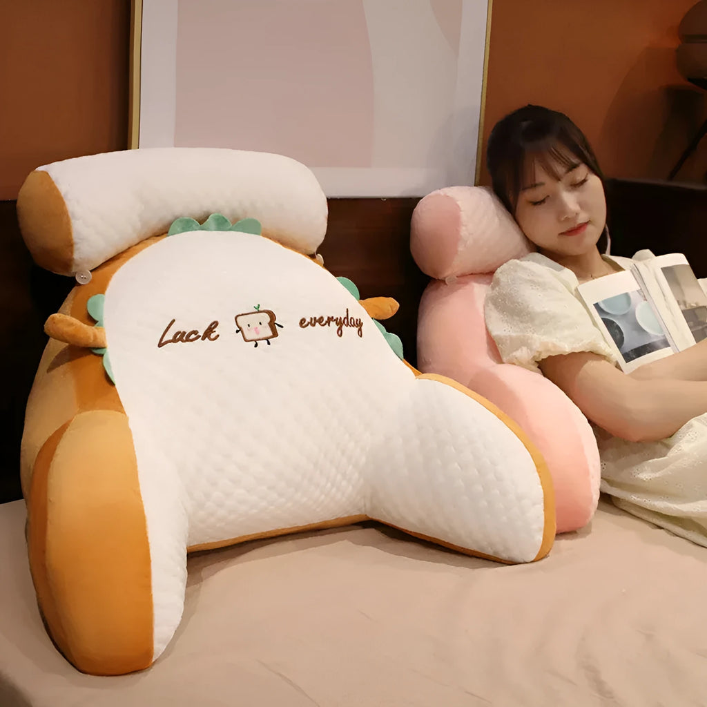 Large fluffy reading cushion with lumbar support in a dinosaur design on a sofa.