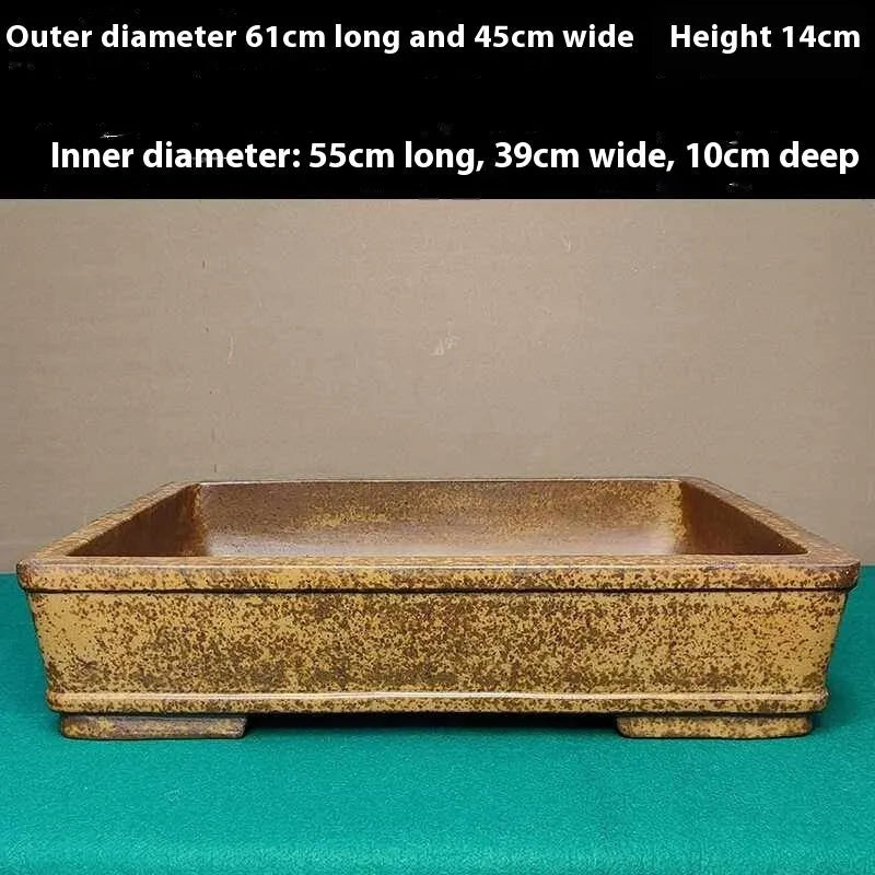 Straight shallow rectangular Yixing purple sand flowerpot for plants on a surface.
