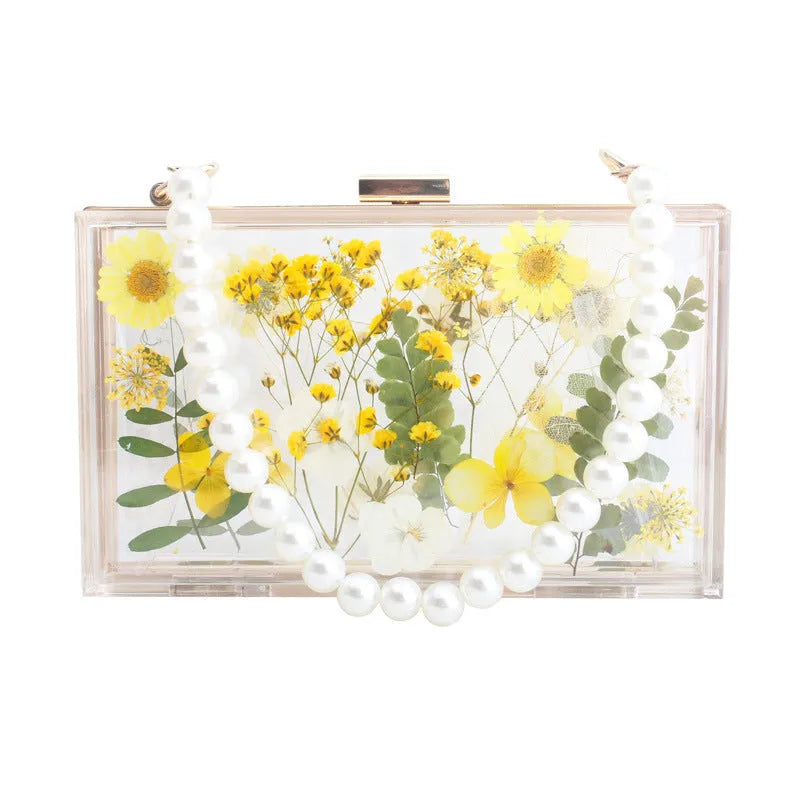 Acrylic transparent flower shoulder messenger bag with hard outer, horizontal square shape, O-shaped necklace, shown in blue.