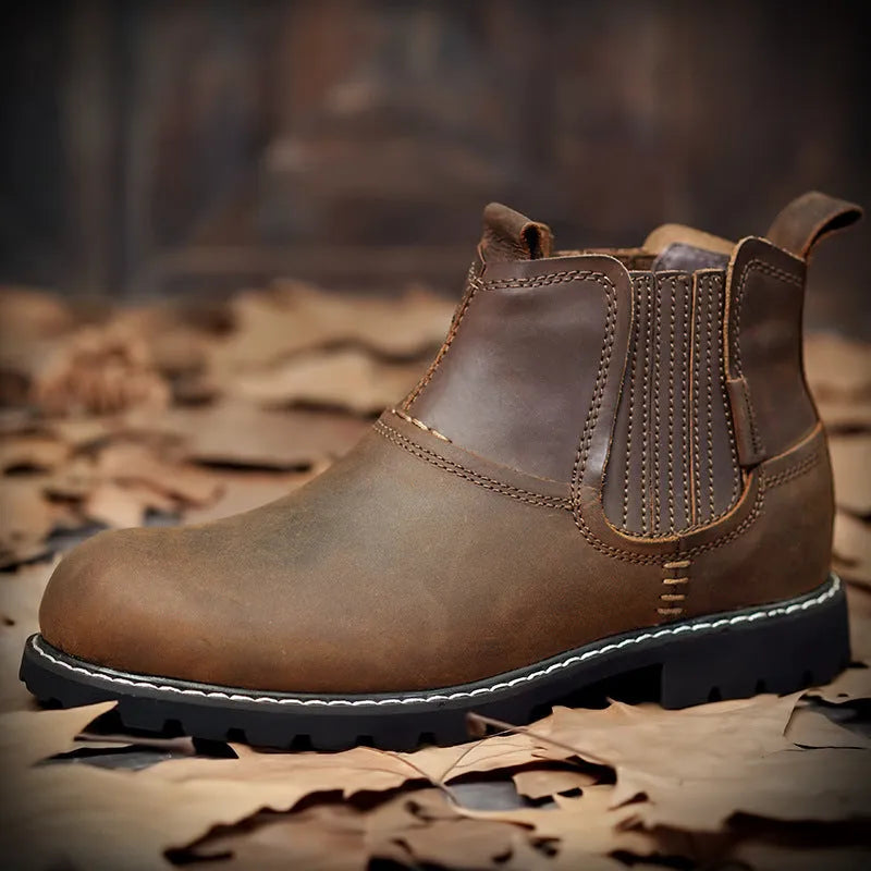 Men's round toe ankle boots in black with lace-up closure and rubber sole on outdoor ground
