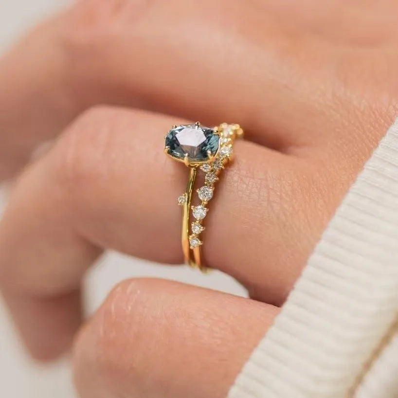 Gold-plated women's ring with green zircon floral design showing side profile