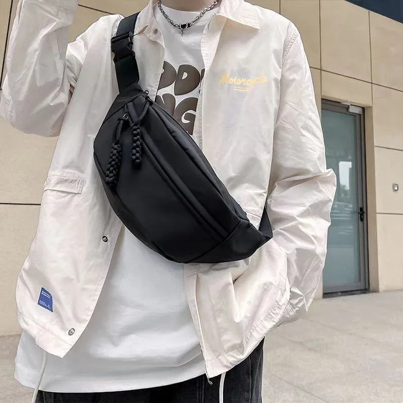 Men's black crossbody chest bag with adjustable shoulder strap showing front compartment