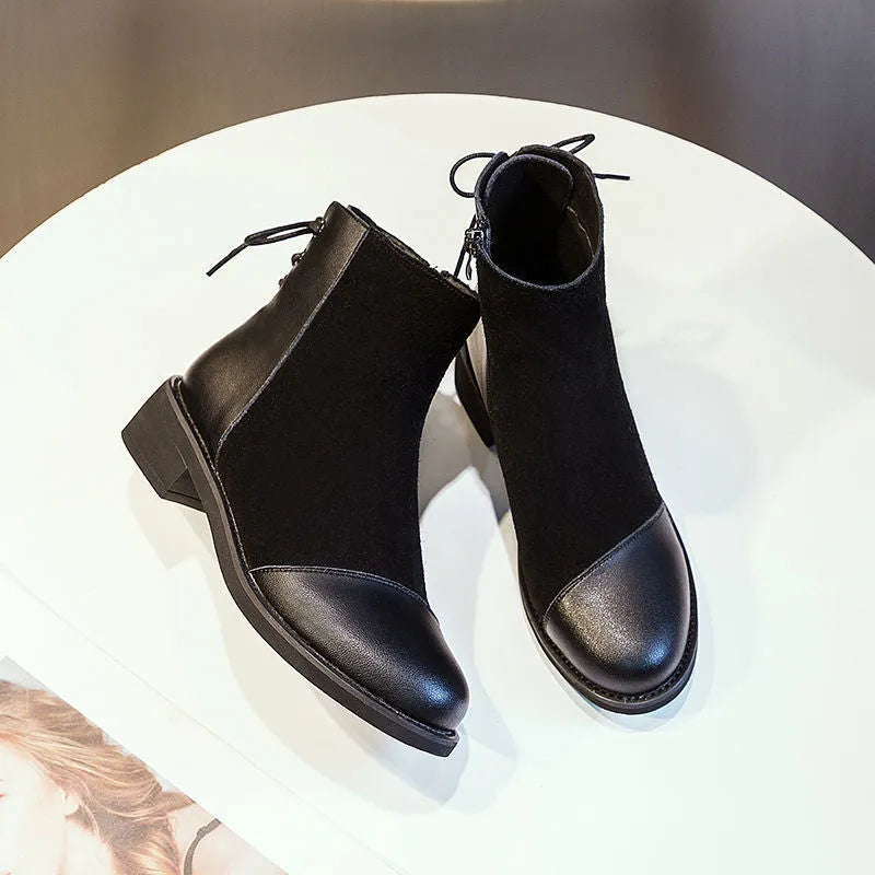 Black women's knee-high Martin boots with side zip, round toe, and chunky heel on a non-slip rubber sole.