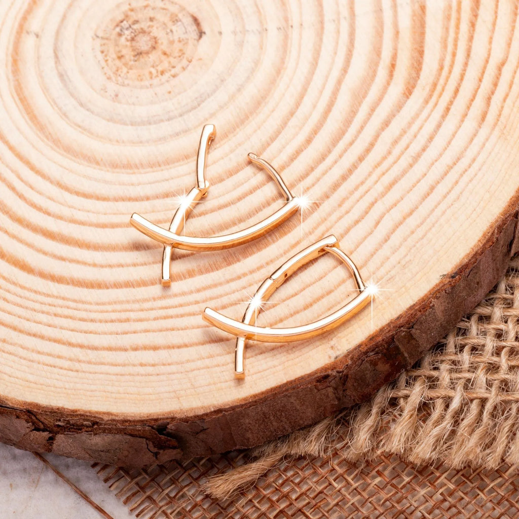 Rose gold coloured cross shaped earrings for women made from copper.