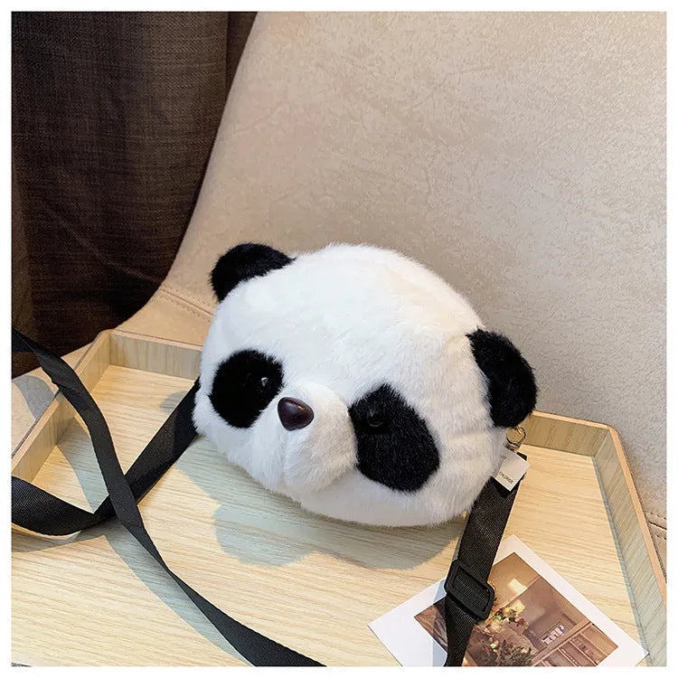 Soft plush cylindrical panda head crossbody bag with a shoulder strap.