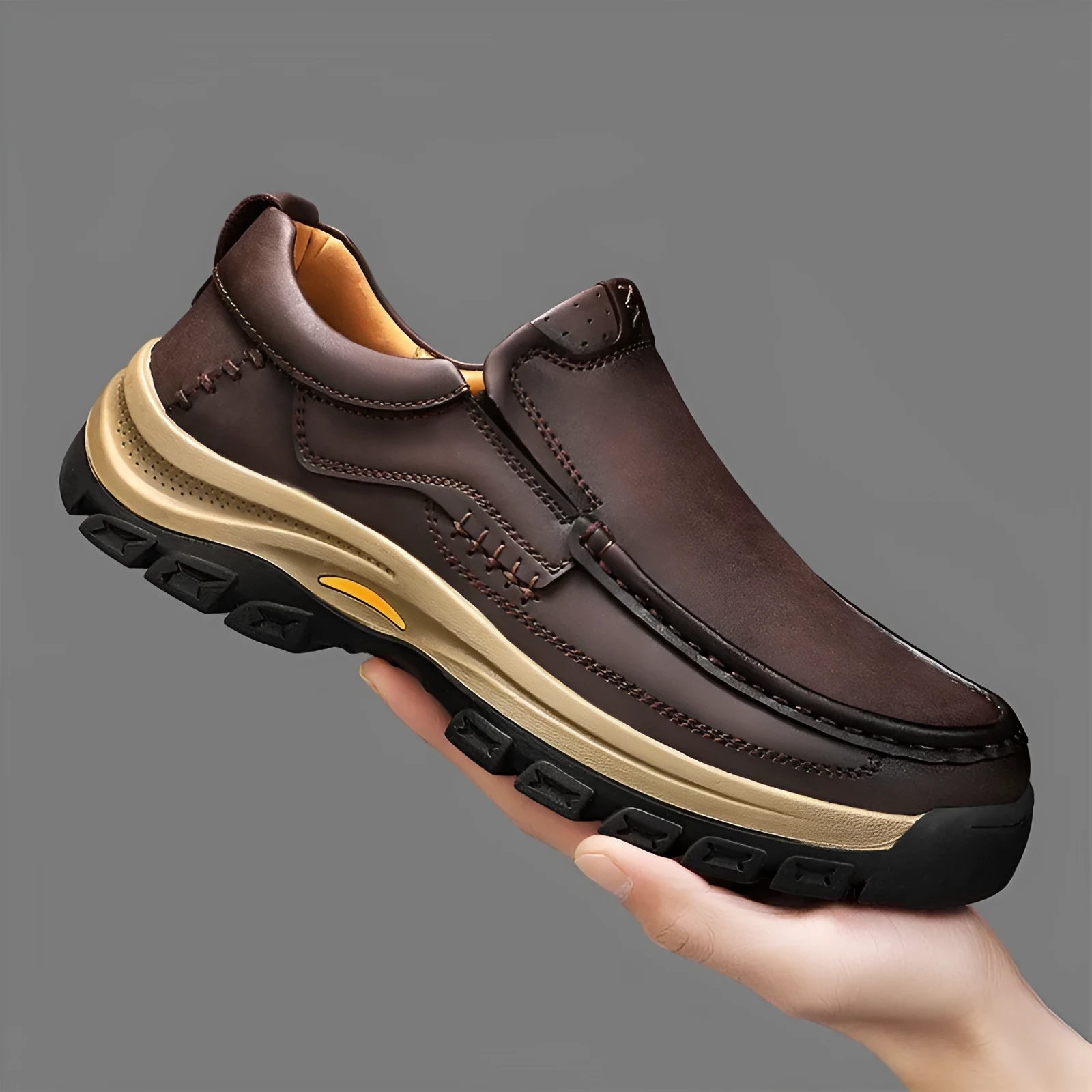 Men's black leather shoes with thick rubber soles and round toe design showing visible sewing thread construction
