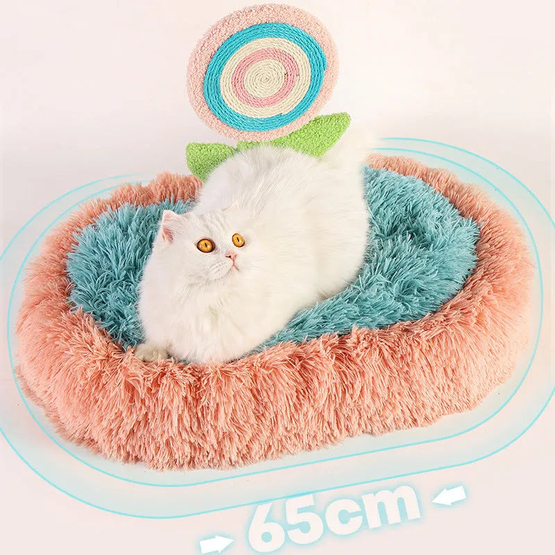 Pink plush elliptical cat bed with integrated lollipop-shaped bolster and removable cover