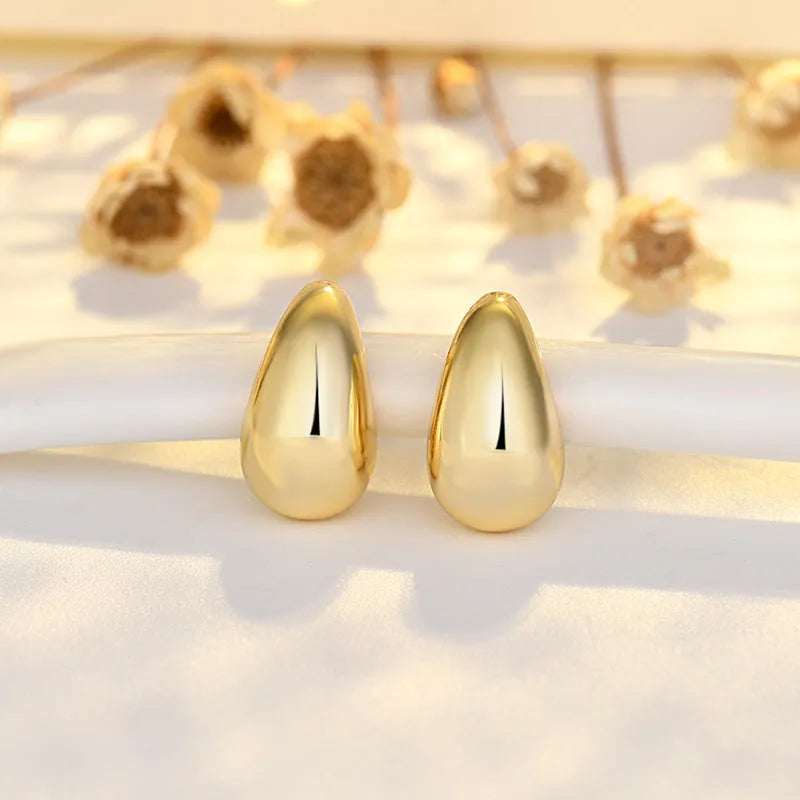 Minimalistic water drop earrings real gold plated copper yellow gold finish on model