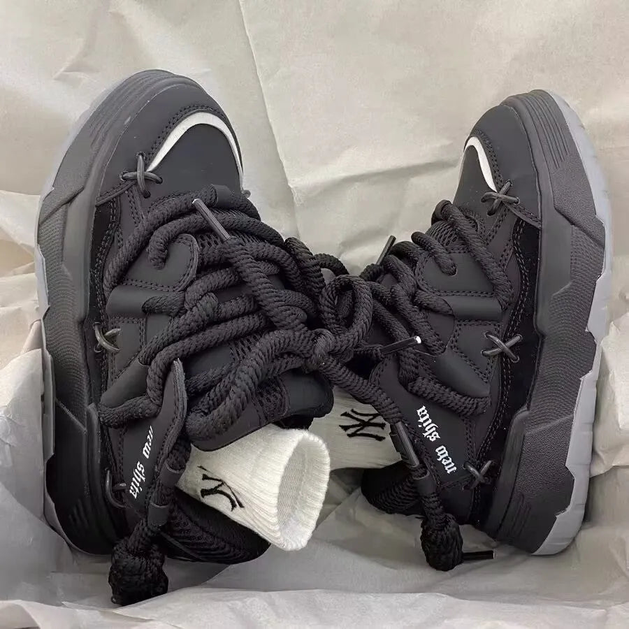 Grey retro clunky sneakers for women with thick sole for height increase and front lace-up closure.
