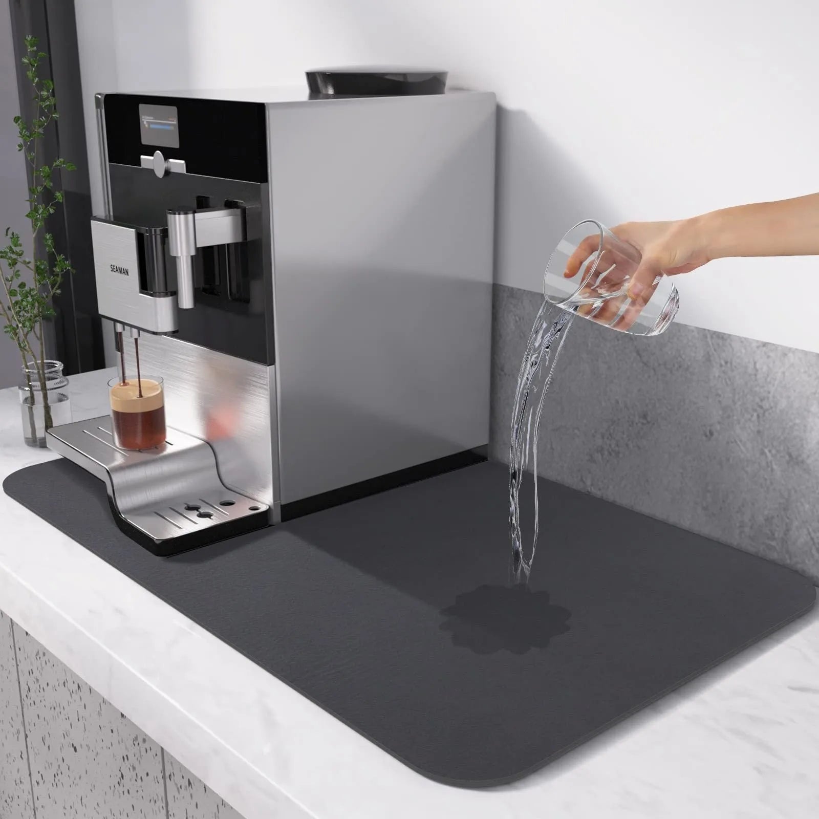 Square black kitchen drain mat with rubber backing placed under coffee machine on countertop