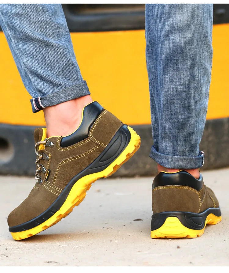 Bronze coloured low-cut cow suede leather safety shoes with a steel toe cap on a work surface.