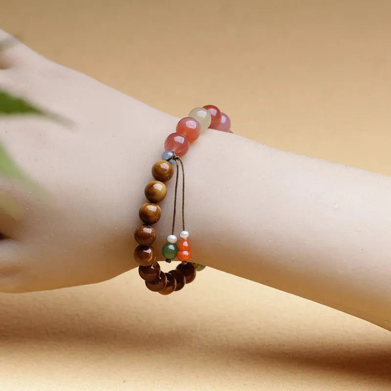 Women's agate bracelet with 8mm diamond-shaped persimmon-coloured beads on a wrist.