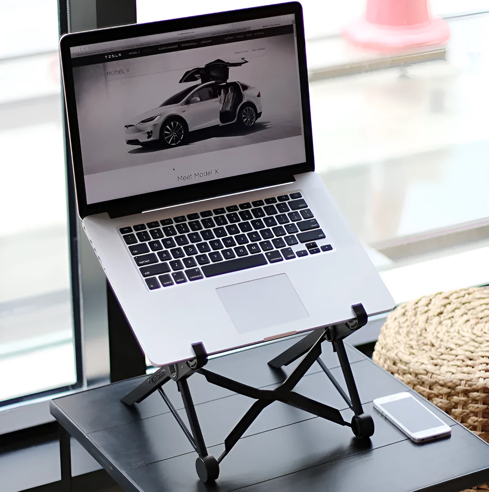 Black folding laptop stand made of reinforced nylon, shown both open and folded to 4 cm