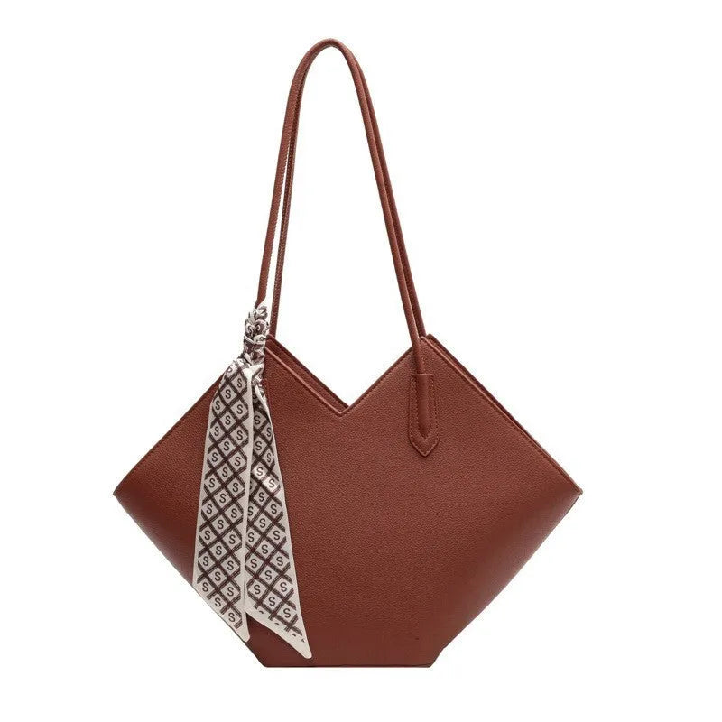 Women's large black PU shoulder bag with square shape and top handle on a neutral background
