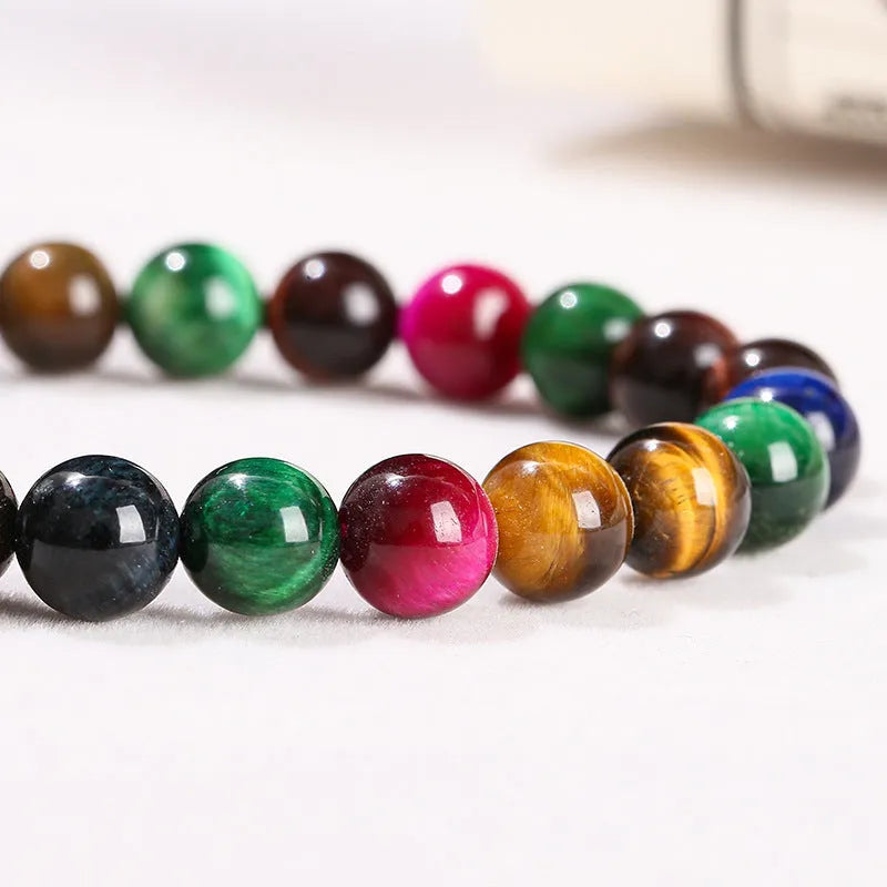 Colourful Tigereye stone bracelet with round beads on a mixed string, showing natural stone variations.