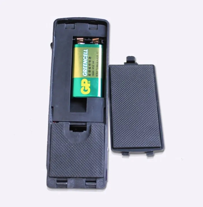 Black portable door stop alarm with wedge shape and stainless steel sensor cover.