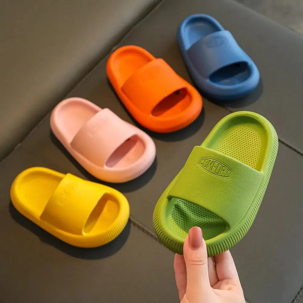 Colourful children's EVA slippers with a textured non-slip sole, shown in blue, green, orange, pink, and yellow.