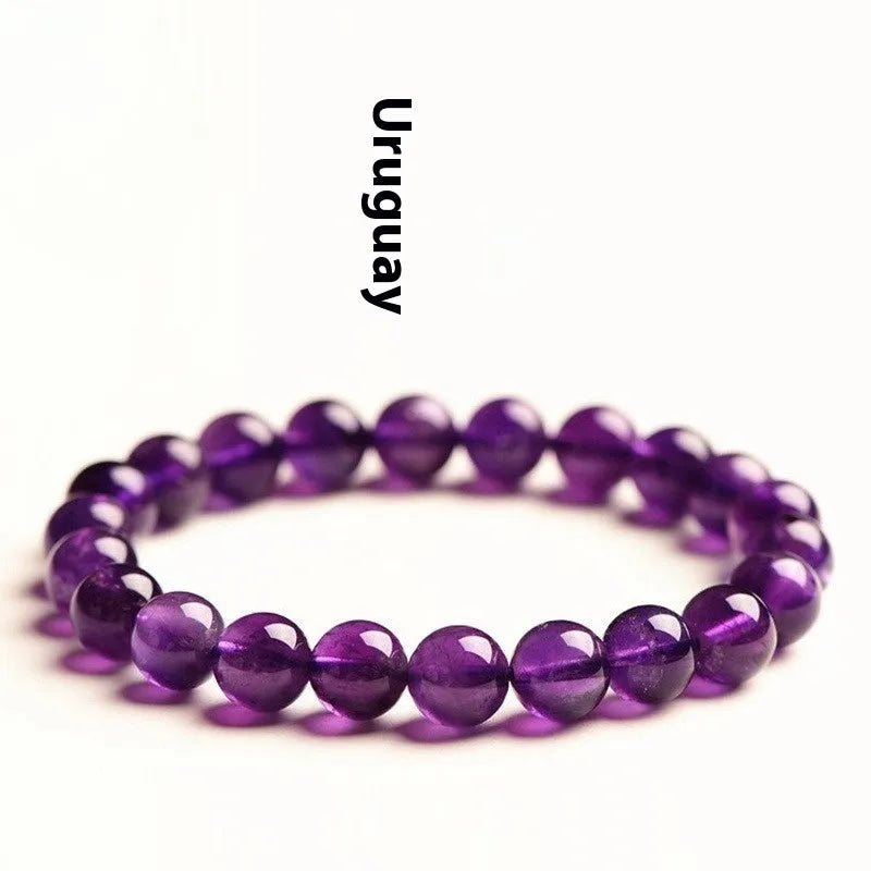 Natural amethyst scattered beads Uruguay bracelet in polished crystal on a white background.