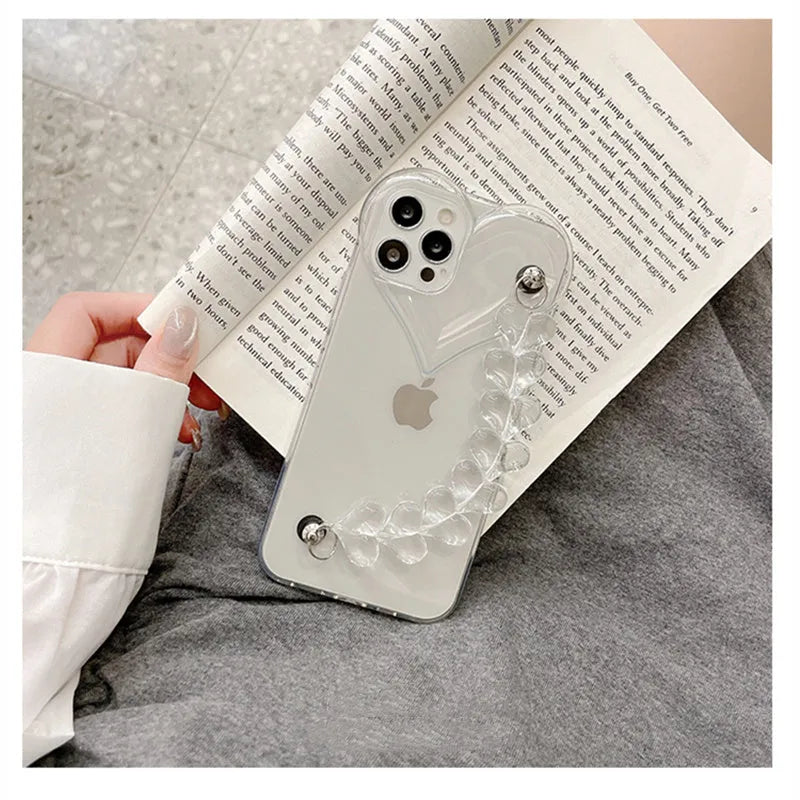 Transparent soft TPU iPhone case with a decorative silver love bracelet chain attached.