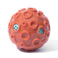 Durable dog chew toy ball with coloured rubber surface featuring tooth-cleaning bumps