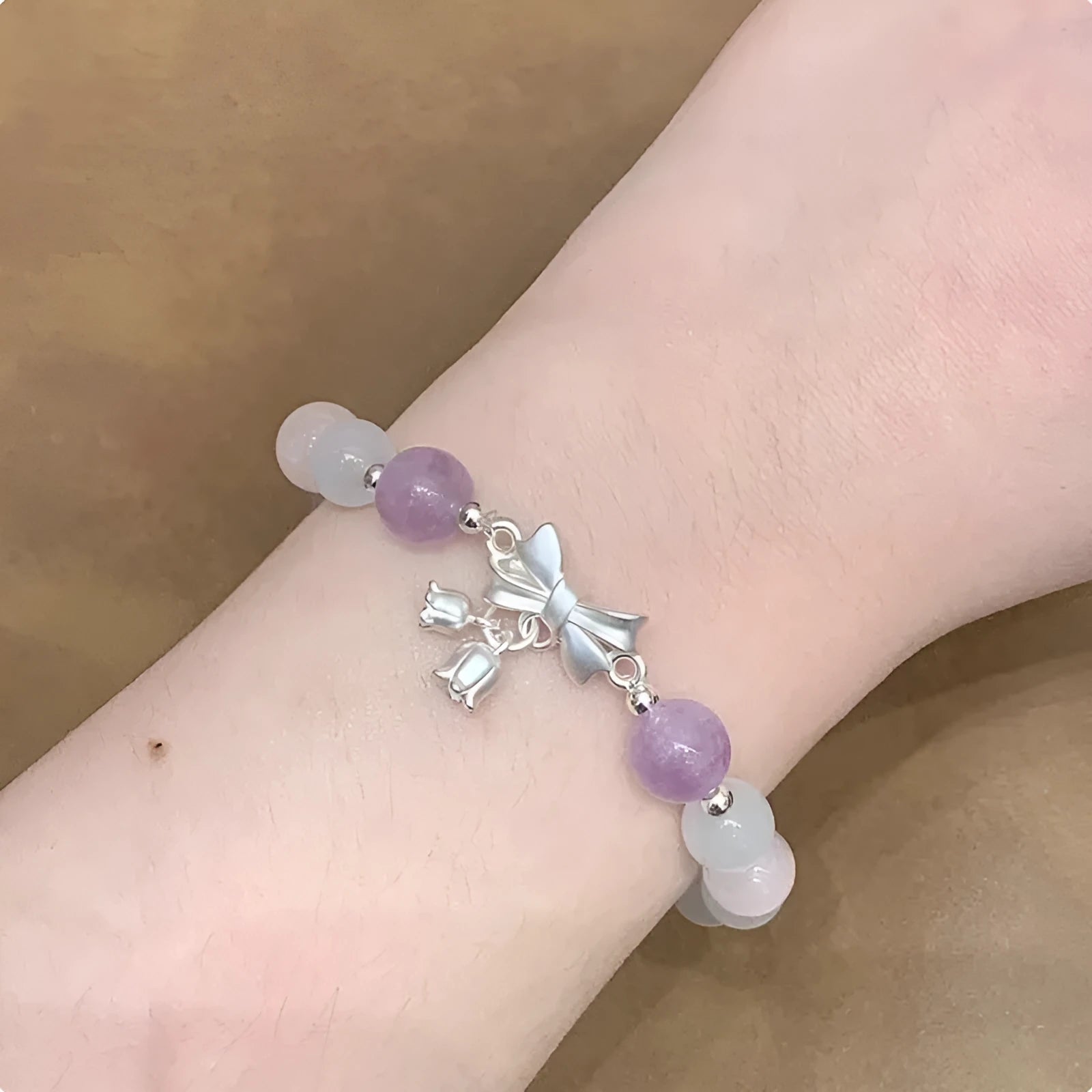 Lavender purple bowknot opal crystal bracelet with electroplated finish for women.