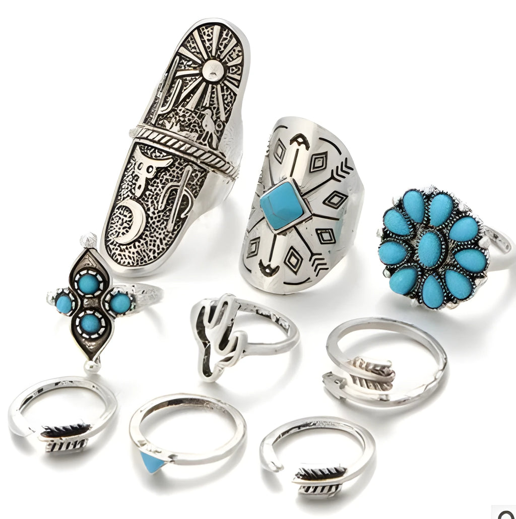Boho vintage ring set in ancient silver with flower engraving and gemstone inlay laid out on a flat surface