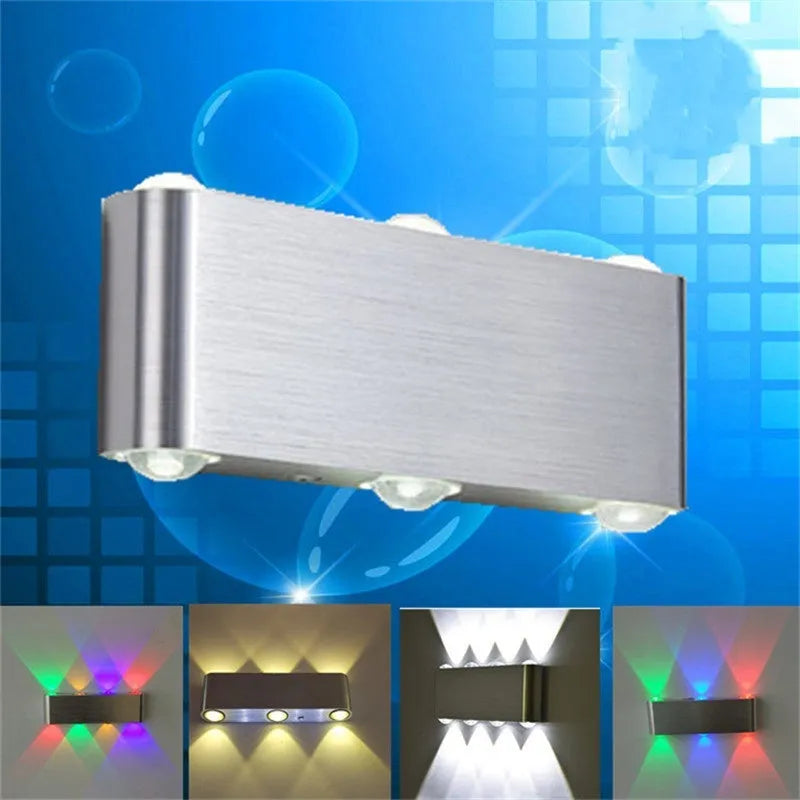 Silver aluminium rectangular LED wall lamp mounted on a wall, displaying multiple light colour options.