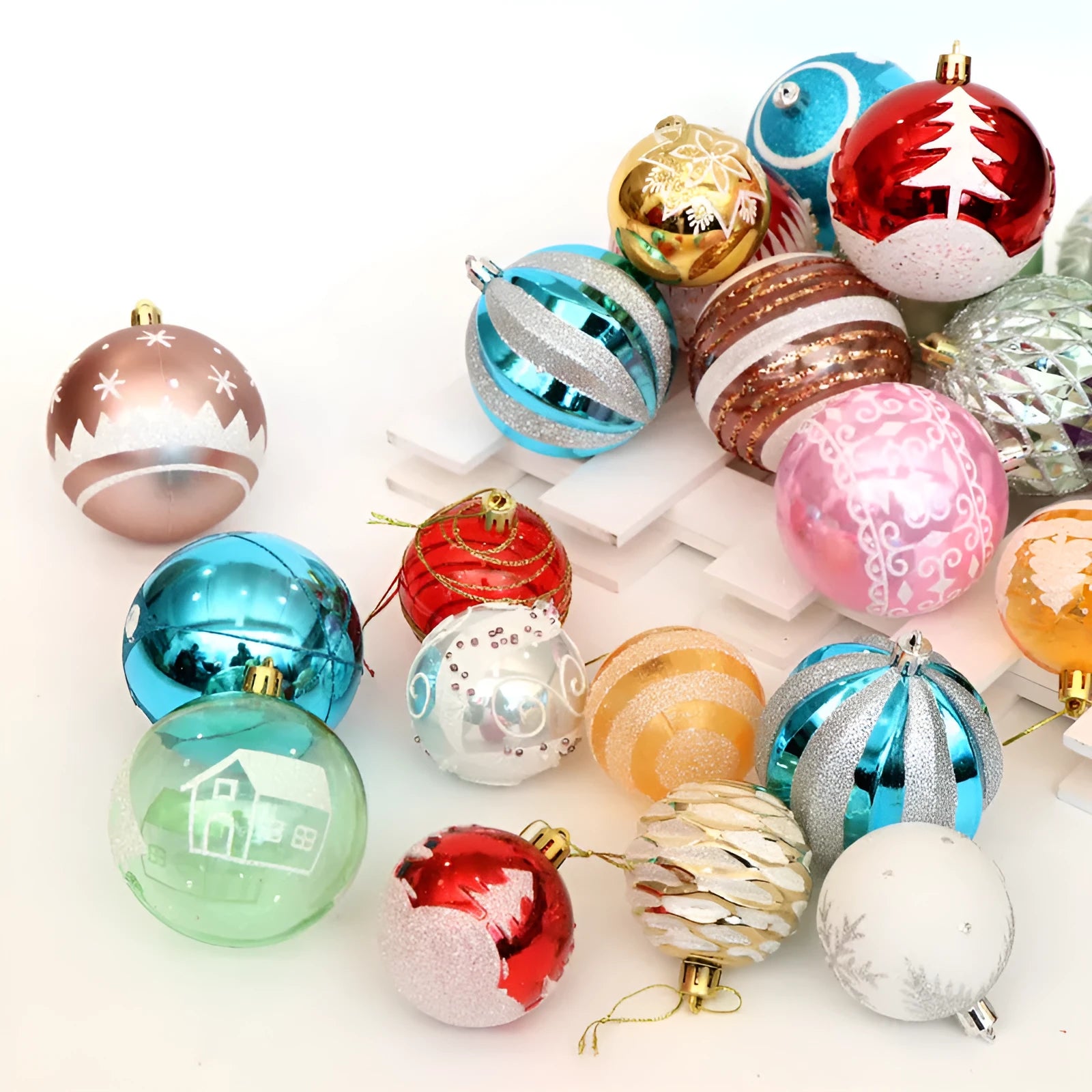 Hand painted 6cm Christmas baubles in various colours including red, gold, green, and blue.
