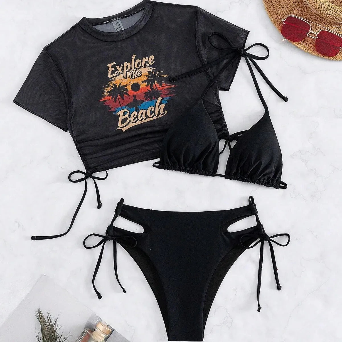 Women's three-piece bikini swimsuit set in black, showing short sleeve cover-up, bra, and bottoms.