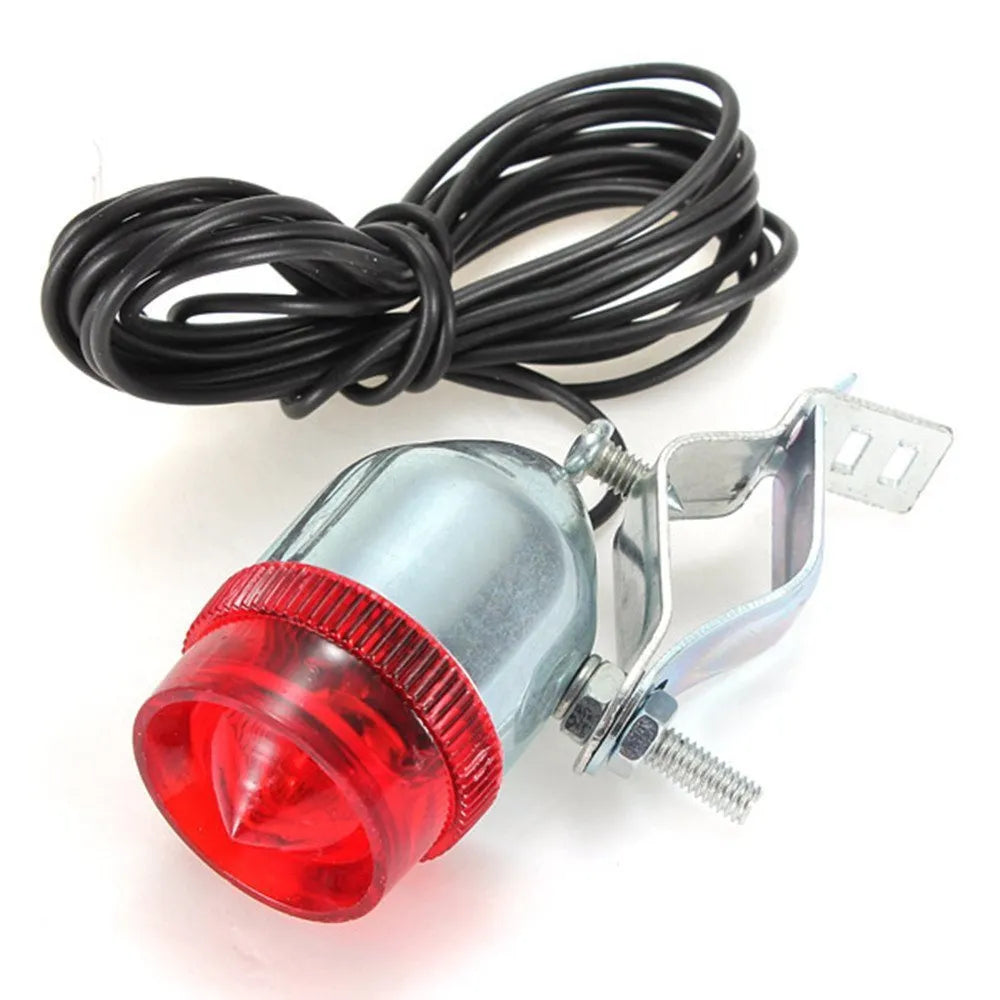 Silver bicycle dynamo generator light kit mounted on a bike frame for friction-powered 12V headlight and tail light