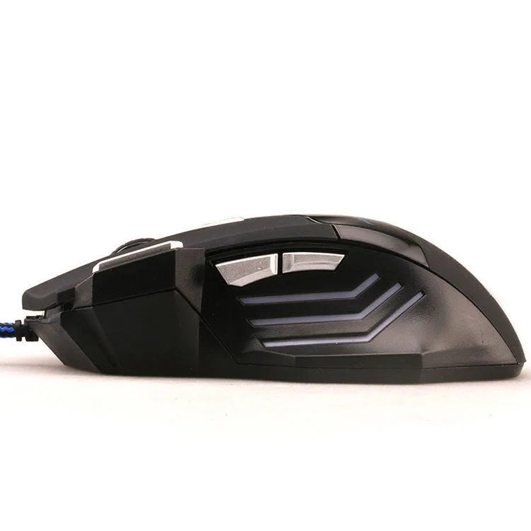 Black wired USB gaming mouse with colourful LED lights and Tyrannosaurus Rex graphic on a desk