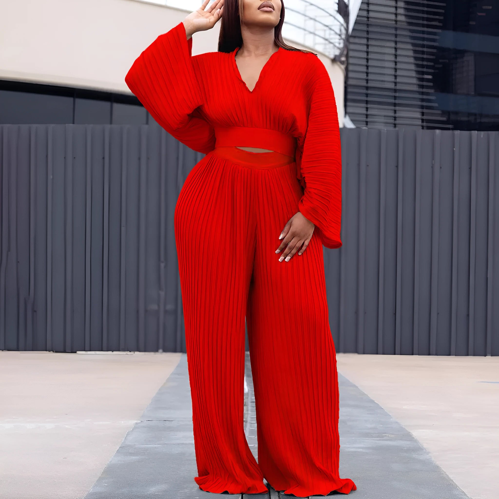 Red African suit two-piece set with batwing sleeve top and wide leg trousers on a mannequin.
