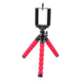 Mini flexible sponge octopus tripod stand holding smartphone on car dashboard