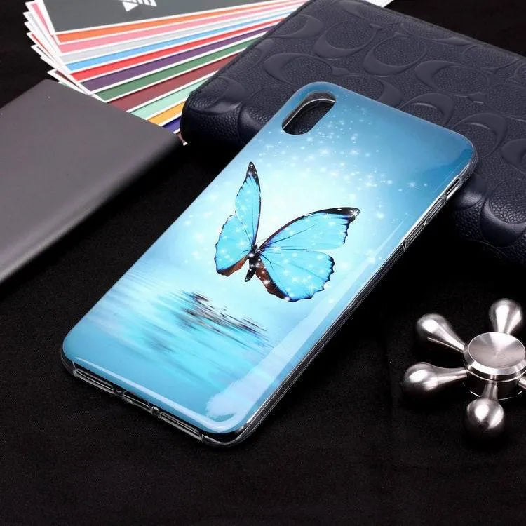 Luminous phone case with cartoon butterfly design for iPhone, glowing in low light.