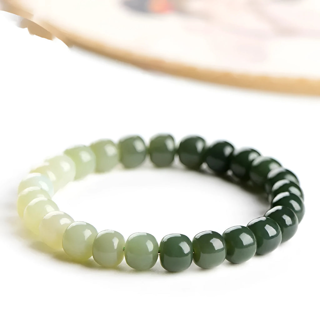 Natural Hetian jade bracelet showing gradient clear to water colour beads on elastic cord