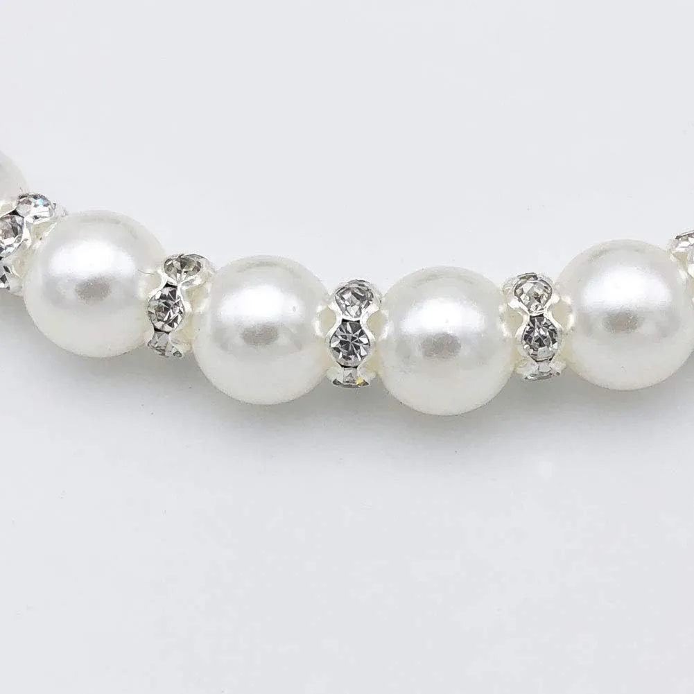 Small dog wearing blue imitation pearl necklace with rhinestones and ribbon bow adjustable collar