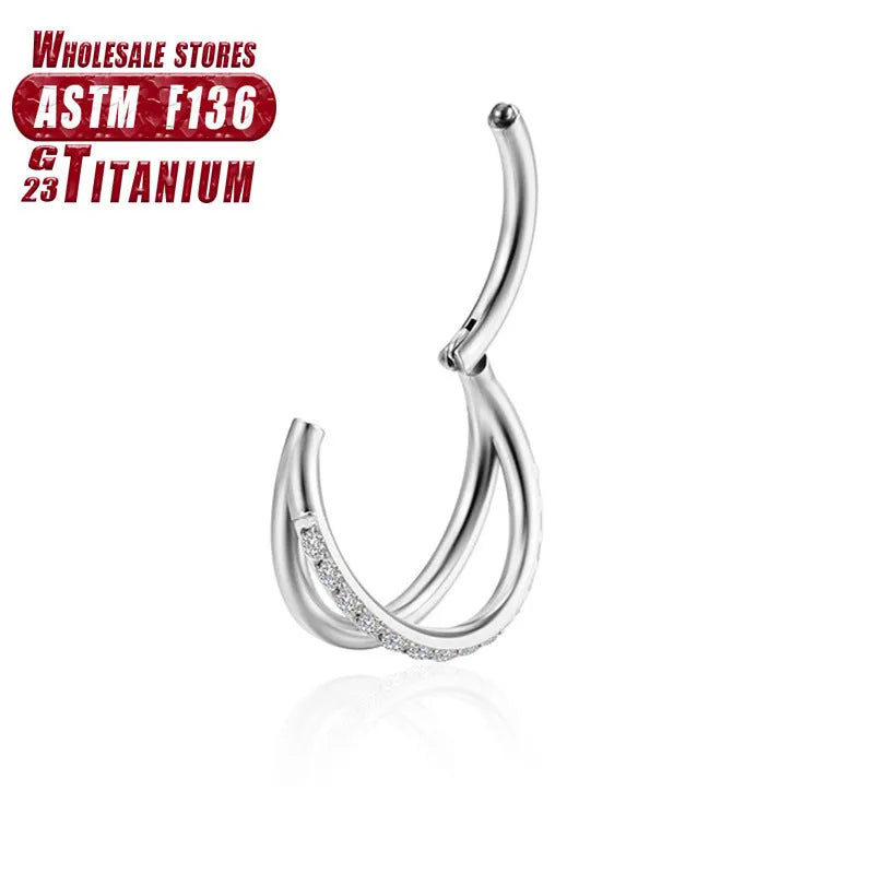 Titanium alloy nose ring body jewellery in silver colour on a plain background.