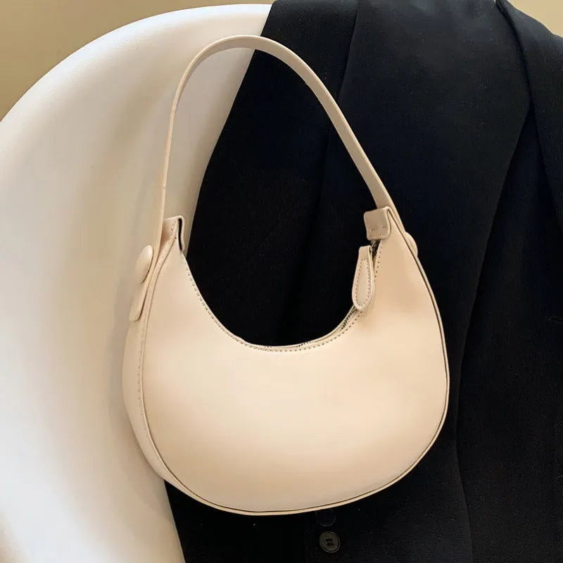Women's retro brown PU dumpling shape shoulder bag with a front pocket shown.