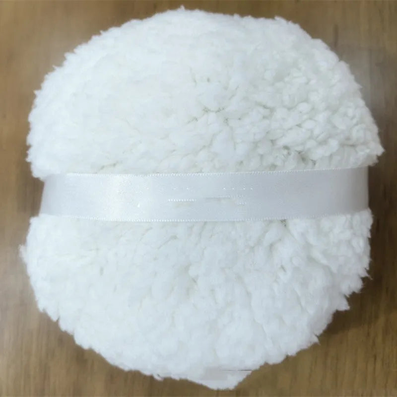 Oversized rectangular plush powder puff in pink on a white background.