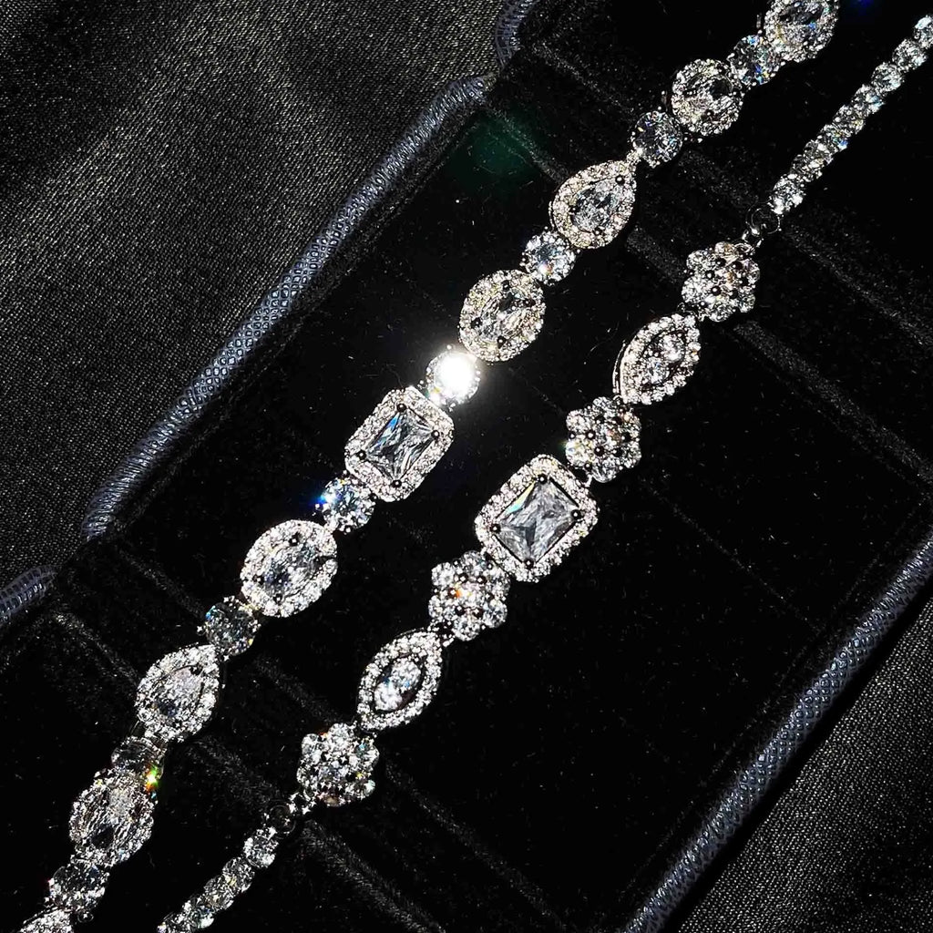 Women's geometric silver-plated bracelet with inlaid zircon stones on a wrist.
