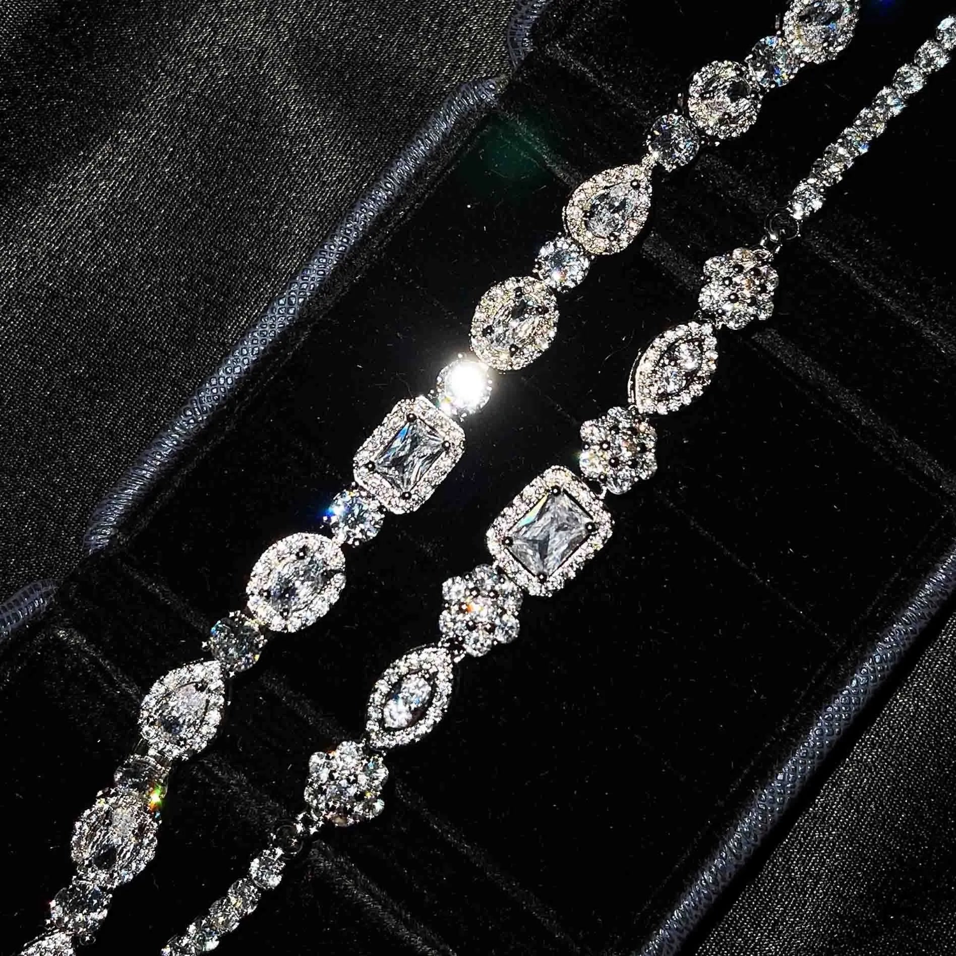 Women's geometric silver-plated bracelet with inlaid zircon stones on a wrist.